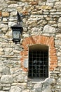 Fragment of the ancient castle with street lamp and a window Royalty Free Stock Photo