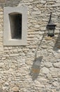 Fragment of the ancient castle with street lamp and a window Royalty Free Stock Photo