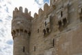 A fragment of the ancient Citadel of Qaitbay on the background of the sky and clouds. Royalty Free Stock Photo