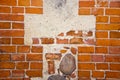 Fragment of ancient red brick wall with stones Royalty Free Stock Photo