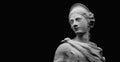 Fragment of an ancient statue of goddess of wisdom and victory Athena on black background. Copy space for text or design