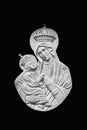 Fragment of ancient statue of Virgin Mary with baby Jesus Christ. Isolated black background Royalty Free Stock Photo