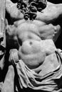 Fragment of an ancient stone statue of Hercules as symbol of power and strength. Black and white horizontal image