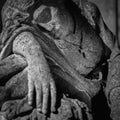 Fragment of an ancient stone statue of sad and desperate woman on tomb as a symbol of death and the end of human life