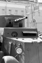 A fragment of an armored vehicle against background of a blurred bus stop sign
