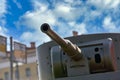 A fragment of an armored vehicle against background of a blurred bus stop sign