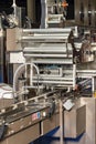 Fragment of an automatic packaging line with roller guides at a food factory Royalty Free Stock Photo