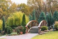 Fragment of an autumn park in Mezhyhirya near Kiev, Ukraine. View of the beautiful bridge over the lake. Royalty Free Stock Photo