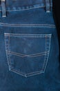 Fragment of back pocket blue jeans