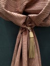 Fragment of beautiful brown curtains with holder
