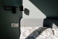 Fragment of a bed in the early morning in bright sunlight, drawing of shadows