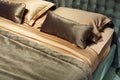 Fragment of a bed in retro style. Soft green back and beige linens. Close-up Royalty Free Stock Photo