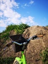 a fragment of a bicycle on the background of the sky and a hill Royalty Free Stock Photo