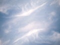A fragment of the blue sky covered with symmetrical white cirrus clouds.