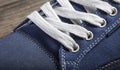 Fragment of a blue sneaker with white drawstring macro Royalty Free Stock Photo