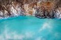 Fragment of blue sulfur toxic lake in the crater of the Ijen volcano. Poisonous sulfur smoke. Mountain volcanic landscape