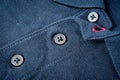 Fragment of a blue T-shirt with a collar and button fastening