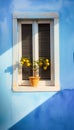 Fragment of blue wall of an old house with wooden window and potted orange tree. Mediterranean architecture style Royalty Free Stock Photo