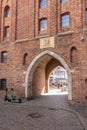 Fragment of a brick wall of an old building with a gate in the old town of Gdansk, Polan