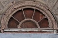 Fragment of building, halfround wooden window Royalty Free Stock Photo