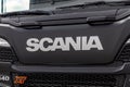 Fragment of the cab of the new Scania heavy truck. Scania logo on the protective grille. A close-up of the front of a