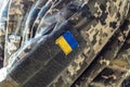 Fragment of camouflage uniform of Ukrainian soldier, close-up of the Ukrainian flag on the sleeve