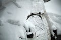 Fragment of a car under a large snowdrift. Close-up. Selective focus