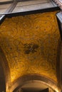 Fragment of a ceiling covered with golden mosaic and Byzantine eagle in Naples, Italy