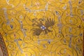 Fragment of a ceiling covered with golden mosaic and Byzantine eagle in Naples, Italy