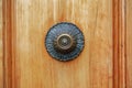Fragment of classic wood front door with brass round decorative door handle