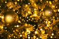 Fragment close up of a decorated christmas tree with golden balls and garland. Winter holiday background Royalty Free Stock Photo