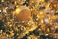 Fragment close up of a decorated christmas tree with golden balls and garland. Winter holiday background Royalty Free Stock Photo