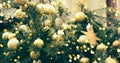 Fragment close up of a decorated christmas tree with golden balls and garland. Winter holiday background Royalty Free Stock Photo