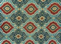 Fragment of colorful retro tapestry textile pattern with floral ornament useful as background Royalty Free Stock Photo