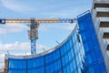 Construction of a high-rise office building and facade window cladding with blue glass Royalty Free Stock Photo