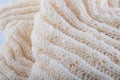 Fragment of creamy handmade wool knitwork