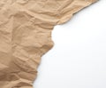 Fragment of crumpled blank sheet of brown wrapping kraft paper with torn edges