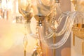 A fragment of the crystal decor of a drop hanging on the transparent glass armature of the ceiling chandelier Royalty Free Stock Photo