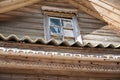 Fragment decor old rural wooden building in russian village. Broken window