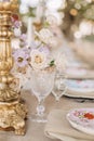 Fragment of decor of wedding table in classic style, bronze cast vintage candlestick, crystal . Royalty Free Stock Photo