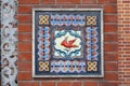 Fragment of the decoration of the facade of building in the form of ceramic tiles with the image of the Phoenix Bird