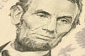 A fragment of a denomination five dollars with a portrait of Abraham Lincoln Royalty Free Stock Photo