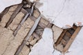 Fragment of the destroyed wall of an old house. Ancient construction technologies. Concrete and wooden slats. Royalty Free Stock Photo