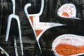 A fragment of detailed graffiti of a drawing made with aerosol paints on a wall of concrete tiles. Background image of street art
