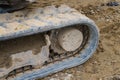 Fragment of a dirty caterpillar of a excavator at a construction site Royalty Free Stock Photo