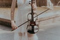 A fragment of an electric violin, a violin in the hands of a musician's girl.