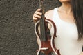 A fragment of an electric violin, a violin in the hands of a musician's girl.
