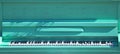 Fragment and exterior of light green piano in a city park in spring. Street music Royalty Free Stock Photo