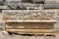 Fragment of the facade with the image of stone masks of the Greco-Roman amphitheater of the ancient city of Myra in Demre