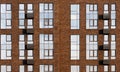 Fragment of the facade of a modern brick building. Texture materials. High windows and suspensions for air conditioner